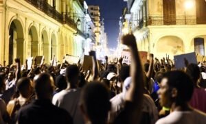 Protest at night in Cuba with many people in the middle of the street
