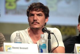 Pedro Pascal speaking at a panel while seated, photo credit: wikimedia commons