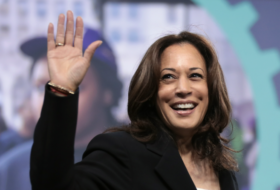 Kamala Harris smiling and waving