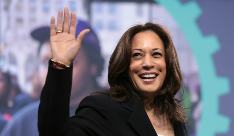 Kamala Harris smiling and waving