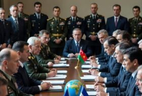 A room full of leaders at the negotiating table