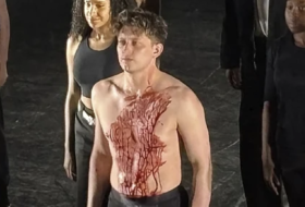 Actor Tom Francis on stage with only underwear on