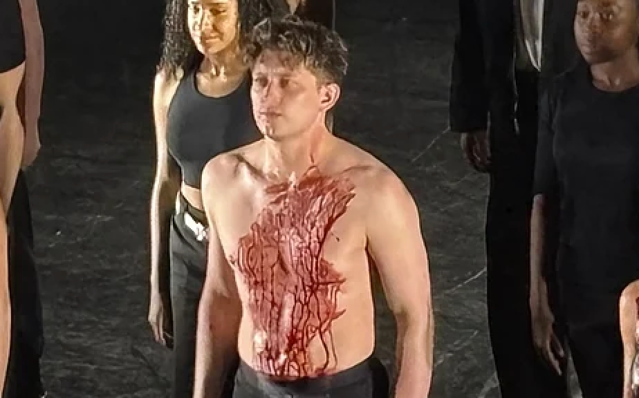 Actor Tom Francis on stage with only underwear on