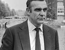 Sean Connery as James Bond with river and bridge in background