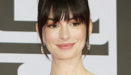 Anne Hathaway smiling for the cameras on the red carpet